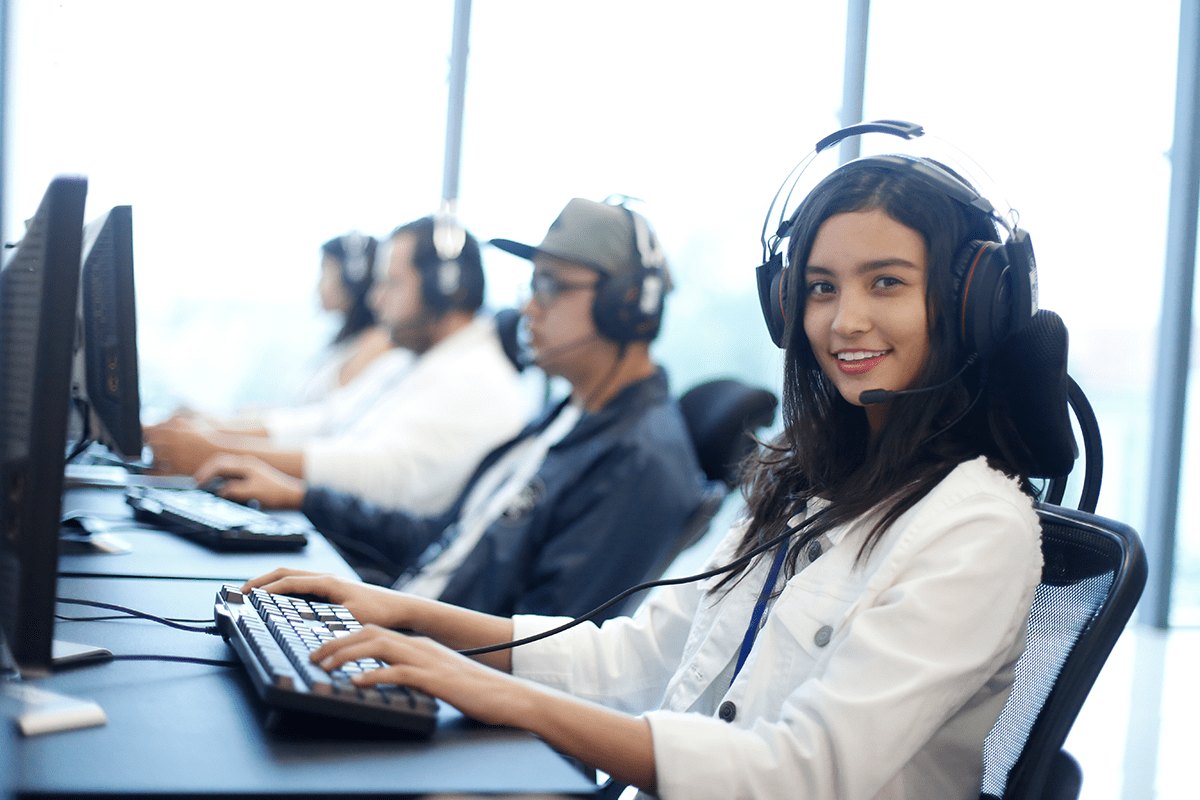 Bilingual agents working with headsets at an AC Net Center work centre